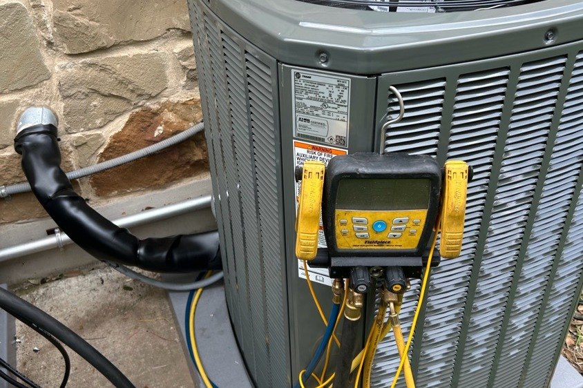 Fieldpiece manifold gauges on a new Trane condenser during charge and startup on a new install